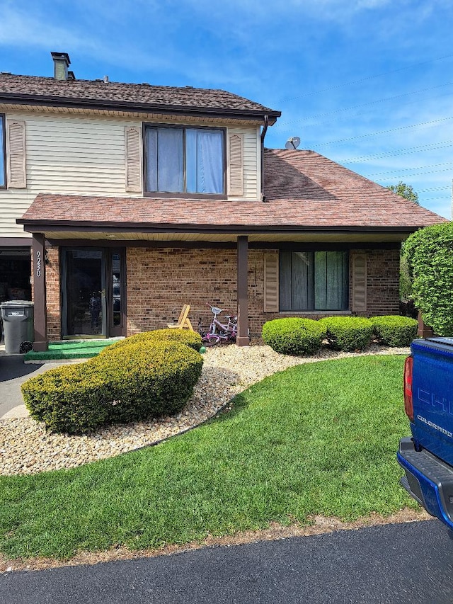 9230 Hartwood Ct Unit 1404, Orland Park, IL 60462 - view of front facade with brick siding, a front yard, and a chimney