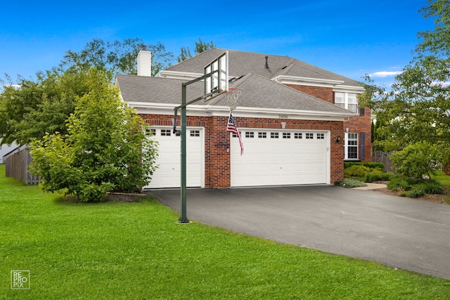 24001 W Walnut Cir, Plainfield, IL 60585 - view of side of home with an attached garage, brick siding, asphalt driveway, a shingled roof, and a chimney