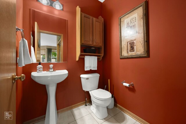 24001 W Walnut Cir, Plainfield, IL 60585 - bathroom featuring toilet, baseboards, tile patterned flooring, and a sink