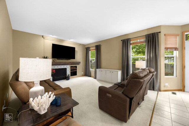 24001 W Walnut Cir, Plainfield, IL 60585 - living room with a tile fireplace, baseboards, and light tile patterned floors