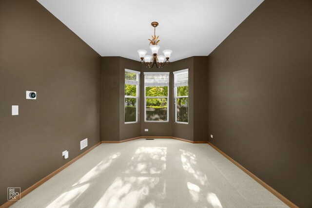 24001 W Walnut Cir, Plainfield, IL 60585 - empty room with a chandelier, light colored carpet, and baseboards