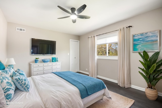 bedroom with dark wood finished floors, baseboards, and ceiling fan