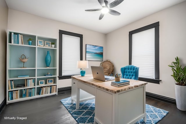 office area with a ceiling fan, dark wood-type flooring, healthy amount of natural light, and baseboards