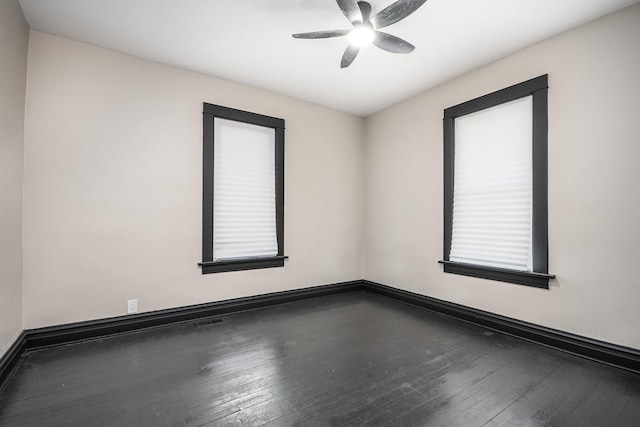 unfurnished room with a ceiling fan, wood-type flooring, and baseboards