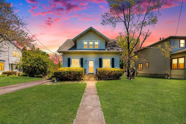bungalow-style home featuring a front lawn and a shingled roof