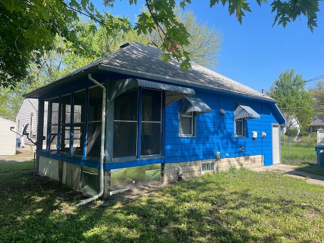 244 N 7th Ave, Kankakee, IL 60901 - view of property exterior with a yard, a sunroom, and a shingled roof