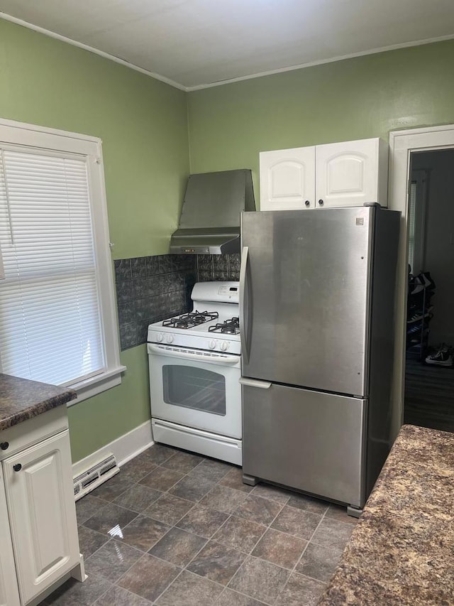 244 N 7th Ave, Kankakee, IL 60901 - kitchen featuring freestanding refrigerator, white gas range, wall chimney exhaust hood, dark countertops, and white cabinets