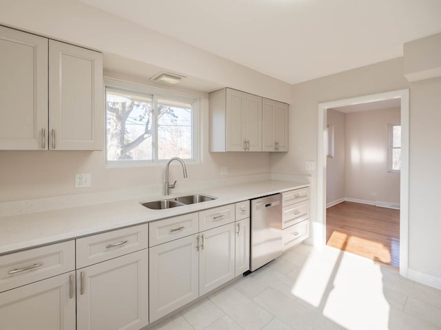 191 Juneway Ter, Lake Bluff, IL 60044 - kitchen featuring stainless steel dishwasher, a sink, plenty of natural light, and light countertops