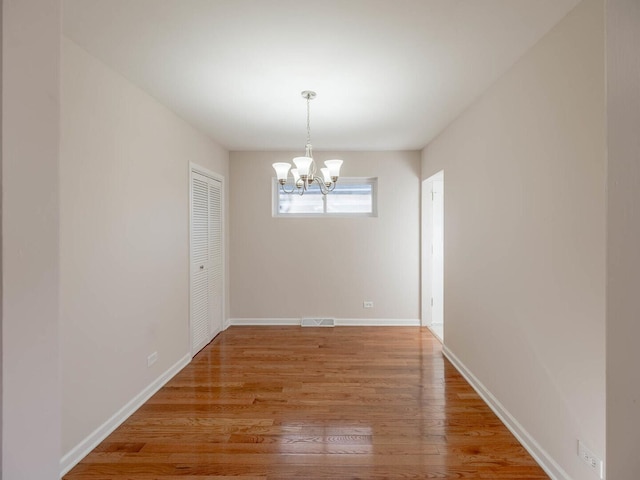 191 Juneway Ter, Lake Bluff, IL 60044 - unfurnished dining area with a chandelier, light wood-style floors, and baseboards