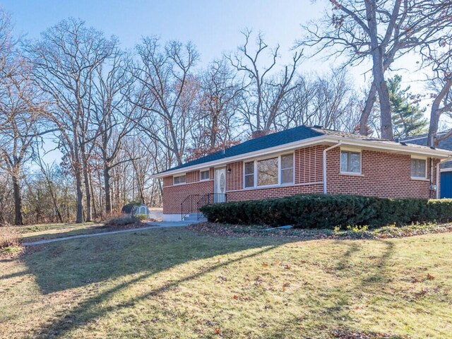 191 Juneway Ter, Lake Bluff, IL 60044 - view of front of house featuring brick siding, a front yard, and a chimney