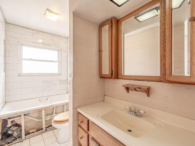 348 Behm Dr, Grayslake, IL 60030 - full bath featuring toilet, a bath, tile patterned flooring, vanity, and tile walls