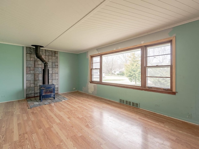 348 Behm Dr, Grayslake, IL 60030 - unfurnished living room with a wood stove, crown molding, and wood finished floors