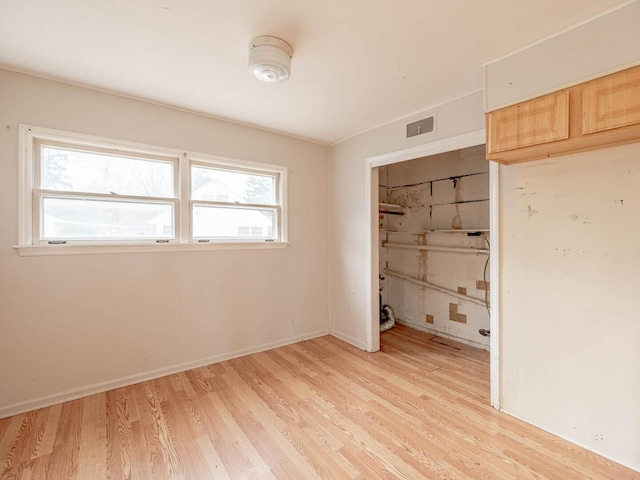 348 Behm Dr, Grayslake, IL 60030 - unfurnished bedroom featuring light wood-type flooring, a closet, and baseboards