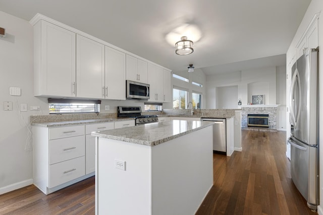 900 Taralon Trl, Lake In The Hills, IL 60156 - kitchen featuring appliances with stainless steel finishes, a peninsula, dark wood finished floors, and white cabinets