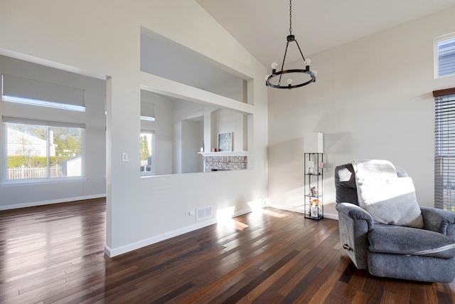 900 Taralon Trl, Lake In The Hills, IL 60156 - living area featuring a fireplace, high vaulted ceiling, a chandelier, dark wood-style flooring, and baseboards
