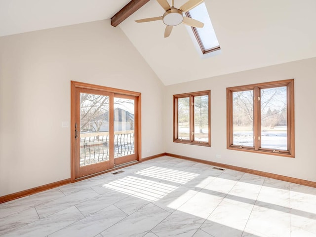 spare room featuring a skylight, beamed ceiling, ceiling fan, baseboards, and high vaulted ceiling