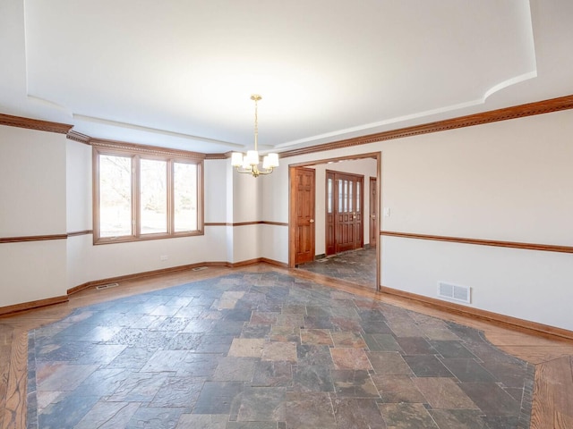 empty room with a chandelier, baseboards, stone tile floors, and crown molding