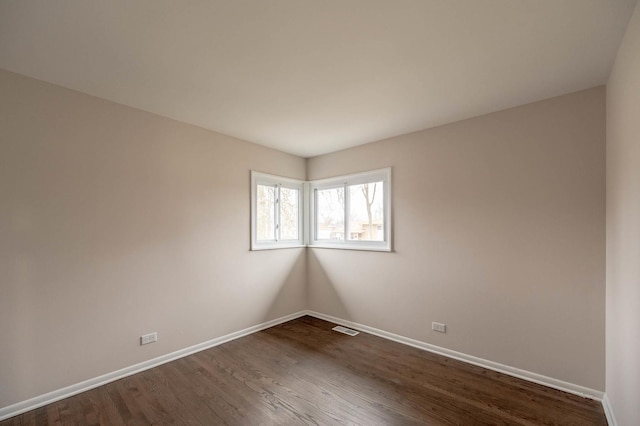 640 Enterprise Rd, Chicago Heights, IL 60411 - spare room featuring baseboards and dark wood finished floors