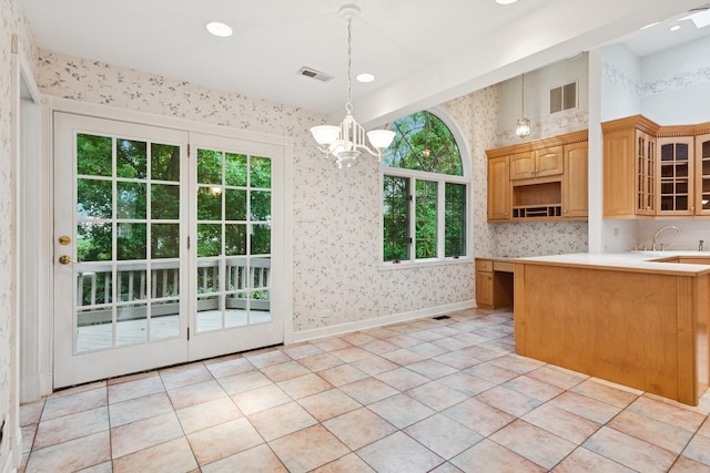 12811 S 82nd Ct, Palos Park, IL 60464 - kitchen featuring wallpapered walls, glass insert cabinets, light countertops, a chandelier, and a sink