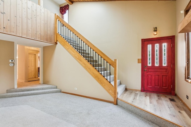 12811 S 82nd Ct, Palos Park, IL 60464 - carpeted foyer entrance featuring high vaulted ceiling, healthy amount of natural light, stairs, wood finished floors, and baseboards