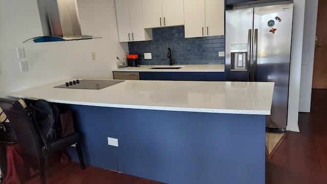 345 N La Salle Dr Unit 3305, Chicago, IL 60654 - kitchen with stainless steel appliances, wall chimney exhaust hood, a sink, wood finished floors, and backsplash