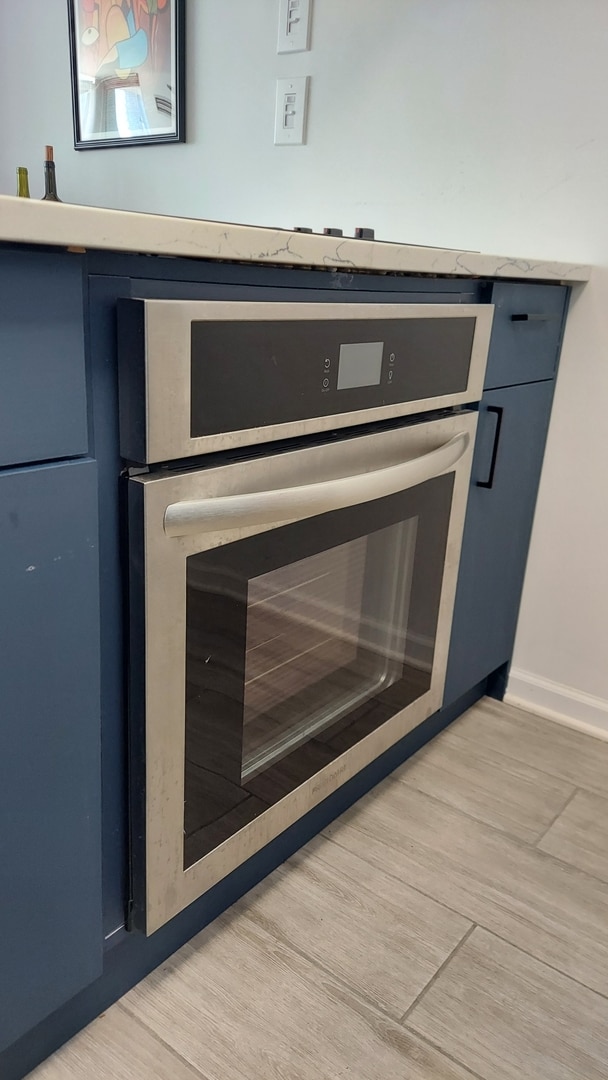 345 N La Salle Dr Unit 3305, Chicago, IL 60654 - kitchen view of stainless steel oven, light wood-type flooring, and baseboards