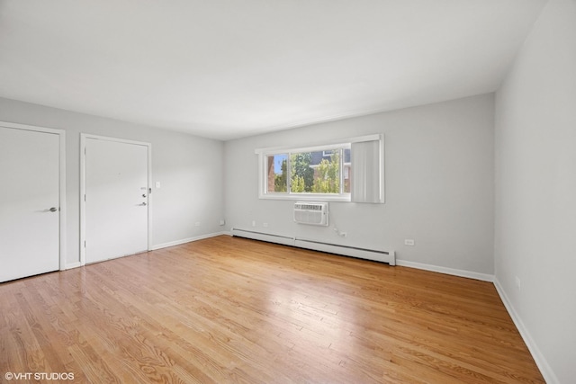 405 Wesley Ave Unit 6, Oak Park, IL 60302 - unfurnished room featuring baseboard heating, light wood finished floors, an AC wall unit, and baseboards