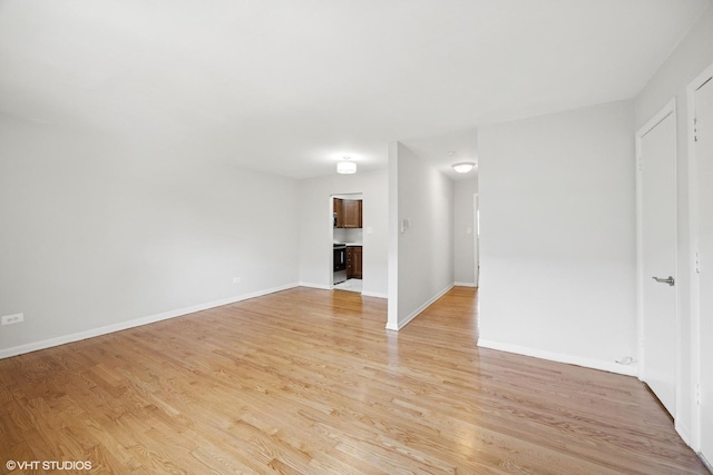 405 Wesley Ave Unit 6, Oak Park, IL 60302 - unfurnished living room with light wood finished floors and baseboards