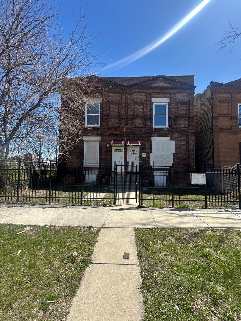 209 N La Crosse Ave, Chicago, IL 60644 - view of front of house featuring a fenced front yard and brick siding