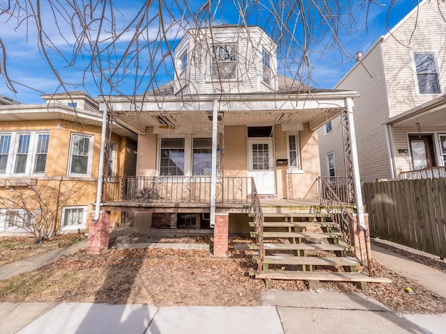 4028 W Roscoe St, Chicago, IL 60641 - view of front facade featuring a porch, brick siding, and fence