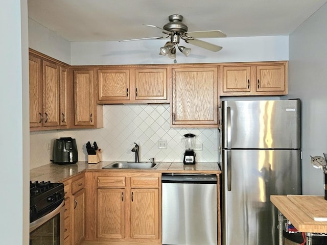 7251 Randolph St Unit C5, Forest Park, IL 60130 - kitchen featuring appliances with stainless steel finishes, a sink, a ceiling fan, backsplash, and light countertops