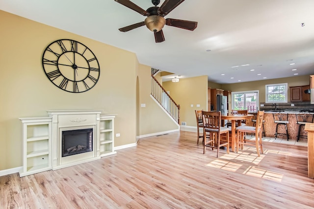 15157 Hilltop Ct, Orland Park, IL 60462 - dining room with light wood finished floors, ceiling fan, stairs, a fireplace, and recessed lighting