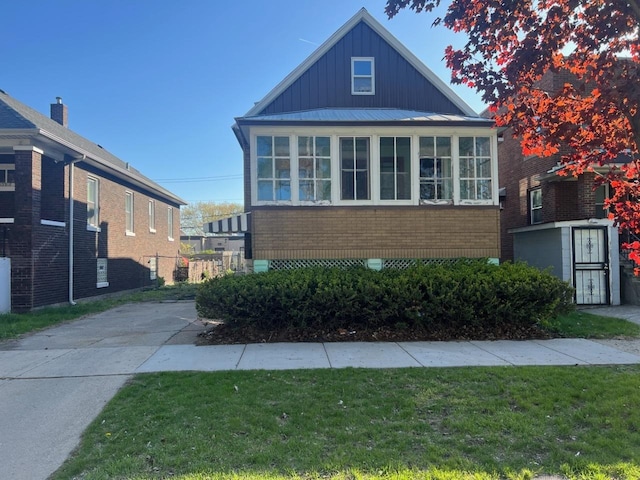 view of front of house with board and batten siding and a front lawn
