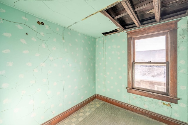 spare room with baseboards
