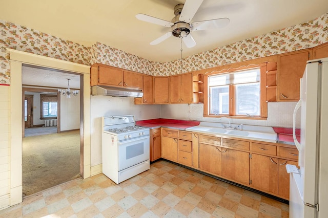 kitchen featuring white appliances, open shelves, under cabinet range hood, radiator, and light floors