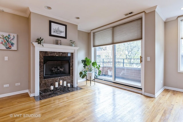 934 W Cuyler Ave Unit 2D, Chicago, IL 60613 - living room featuring crown molding, wood finished floors, baseboards, and a high end fireplace