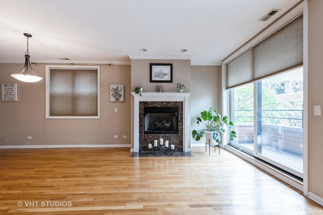 934 W Cuyler Ave Unit 2D, Chicago, IL 60613 - living room featuring ornamental molding, light wood-style floors, baseboards, and a fireplace