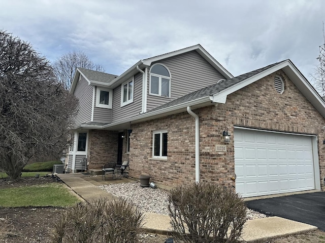 11224 Marley Brook Ct, Orland Park, IL 60467 - view of front of house featuring driveway, a garage, brick siding, and roof with shingles