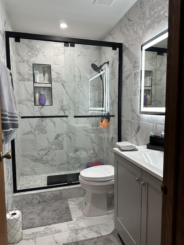 11224 Marley Brook Ct, Orland Park, IL 60467 - bathroom featuring marble finish floors, a stall shower, vanity, tile walls, and toilet