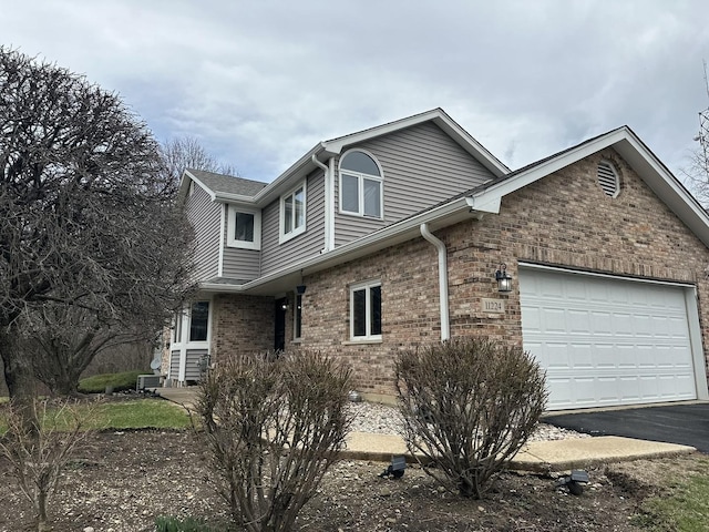 11224 Marley Brook Ct, Orland Park, IL 60467 - view of front of property featuring asphalt driveway, brick siding, and an attached garage