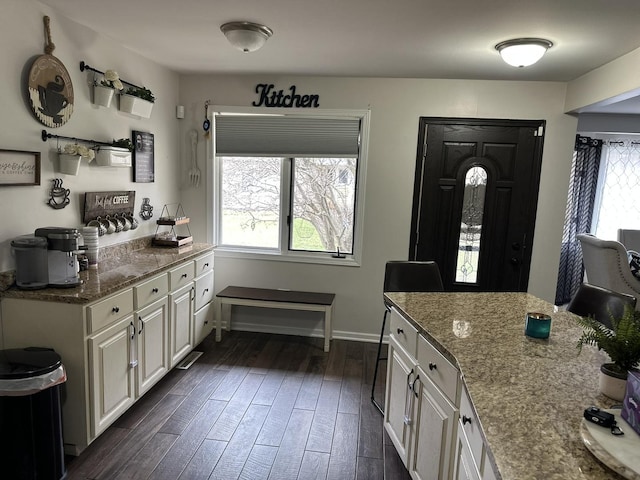 11224 Marley Brook Ct, Orland Park, IL 60467 - kitchen with dark wood finished floors, dark stone countertops, white cabinets, and baseboards
