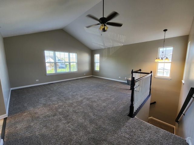2473 Dickens Dr, Aurora, IL 60503 - unfurnished living room featuring ceiling fan, baseboards, carpet flooring, vaulted ceiling, and a chandelier