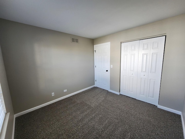 2473 Dickens Dr, Aurora, IL 60503 - unfurnished bedroom featuring baseboards, dark carpet, and a closet