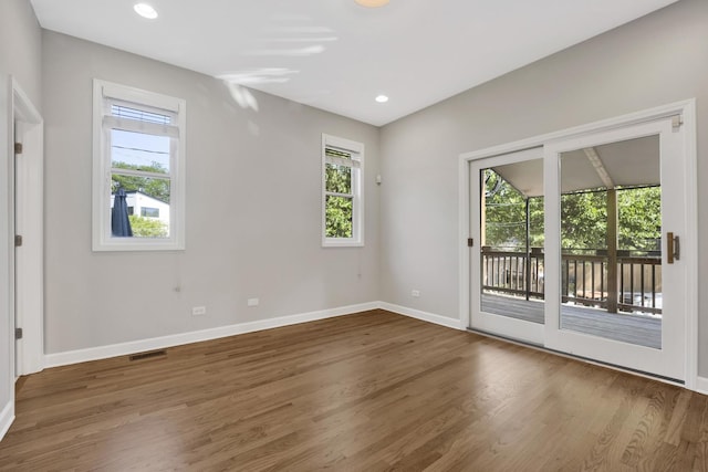 6025 N Ridge Ave Unit 1W, Chicago, IL 60660 - empty room with plenty of natural light, wood finished floors, and recessed lighting
