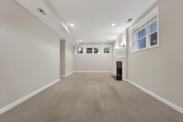 6025 N Ridge Ave Unit 1W, Chicago, IL 60660 - unfurnished living room featuring a fireplace with flush hearth, light carpet, and recessed lighting