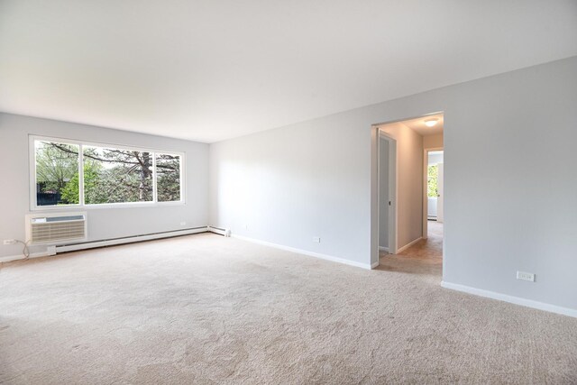 922 E Old Willow Rd Unit 204, Prospect Heights, IL 60070 - empty room with baseboard heating, a wall mounted AC, healthy amount of natural light, and baseboards