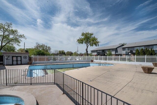 922 E Old Willow Rd Unit 204, Prospect Heights, IL 60070 - community pool featuring a patio area, fence, a storage shed, and an outdoor structure