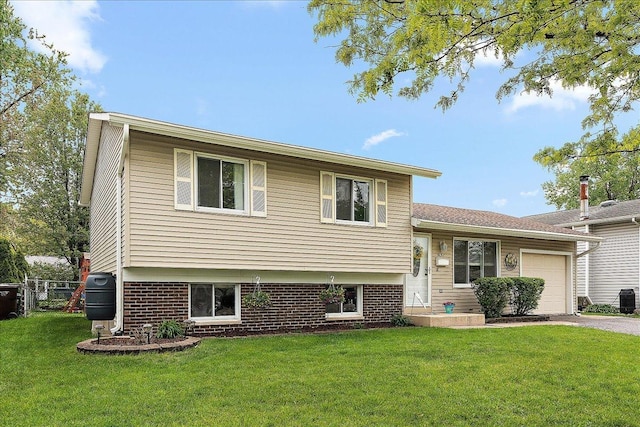 tri-level home with a garage, driveway, brick siding, and central air condition unit