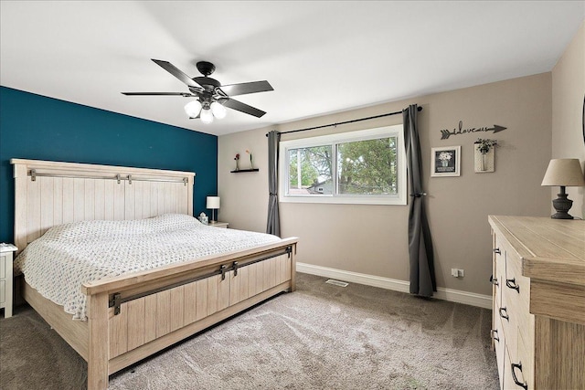 bedroom with light carpet, baseboards, and a ceiling fan