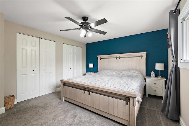 bedroom with multiple closets, carpet, and baseboards